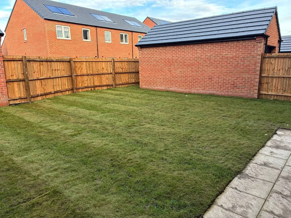 Artificial Grass in Chester. Newly turfed back garden lawn on a new-build home with timber fencing