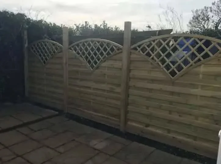 Lattice-top timber fence panels around a paved patio