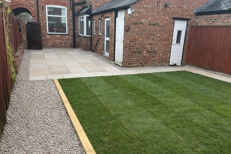 Courtyard landscaping with new lawn, sandstone patio and gravel strip edged in timber