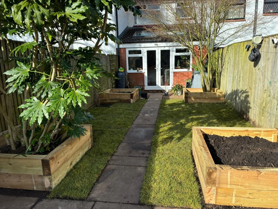 Sleepers & Garden Walls in Chester. Timber sleeper raised beds either side of a paved path and new lawn