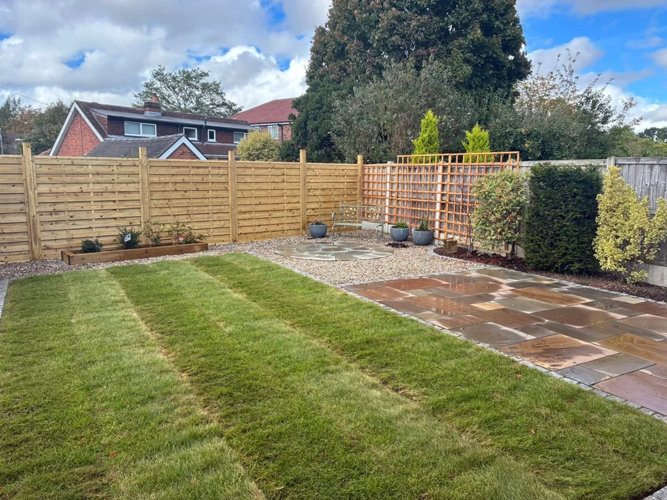 Landscaping in Chester. Landscaped back garden with new lawn, sandstone patio and horizontal slatted fence panels