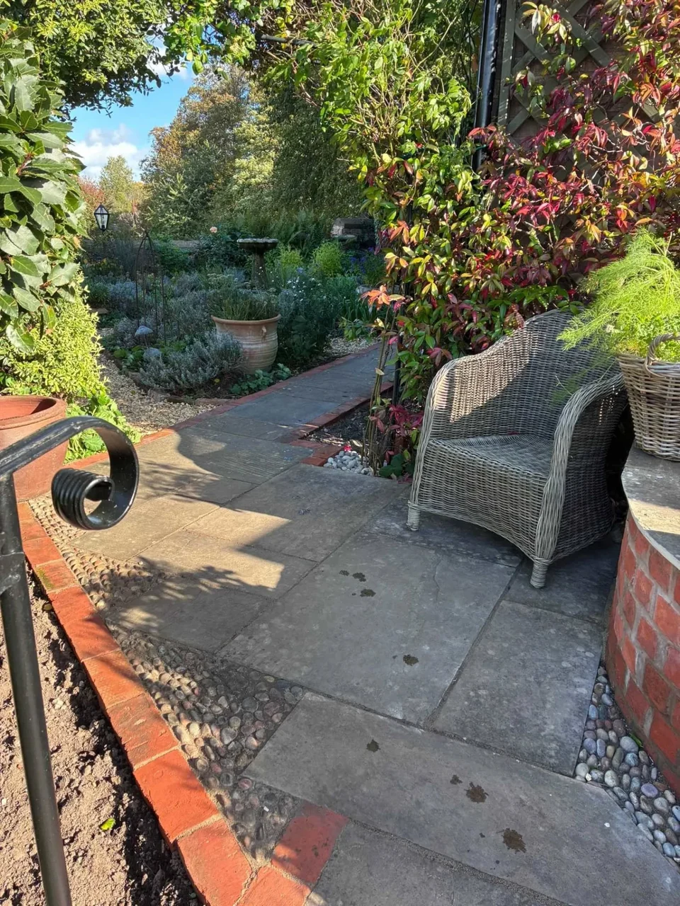 Garden path landscaping with sandstone paving, brick edging and decorative railing